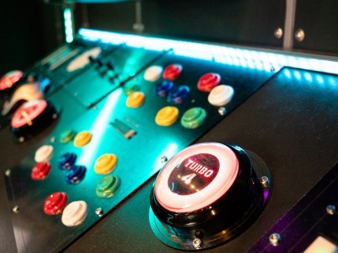 Control panel with colorful buttons and a large 'Turbo' button, illuminated in a futuristic design., © ExitGames Stuttgart Control panel with colorful buttons and a large 'Turbo' button, illuminated in a futuristic design., © ExitGames Stuttgart