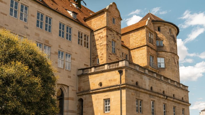 An old castle with striking towers and many windows, surrounded by a blue sky and a few clouds., © Stuttgart-Marketing GmbH, Sarah Schmid