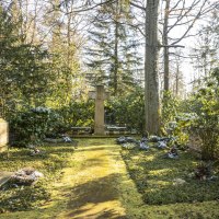 Ein ruhiger Friedhof mit einem gro&szlig;en Kreuz in der Mitte, umgeben von B&auml;umen und gr&uuml;ner Vegetation. Sonnenlicht f&auml;llt durch die Bl&auml;tter., &copy; Stuttgart-Marketing GmbH, Sarah Schmid