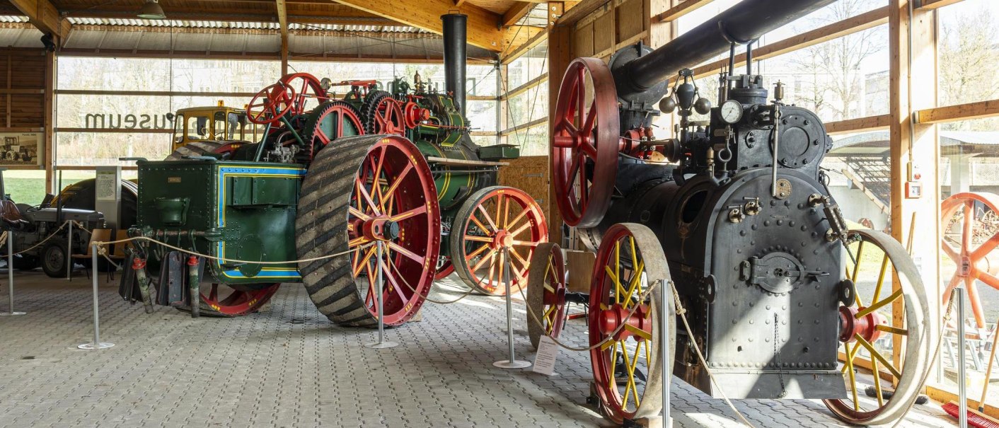 Historic tractors and machines in the German Agricultural Museum, exhibited in a hall with large windows., © Stuttgart Marketing GmbH, Sarah Schmid Historic tractors and machines in the German Agricultural Museum, exhibited in a hall with large windows., © Stuttgart Marketing GmbH, Sarah Schmid