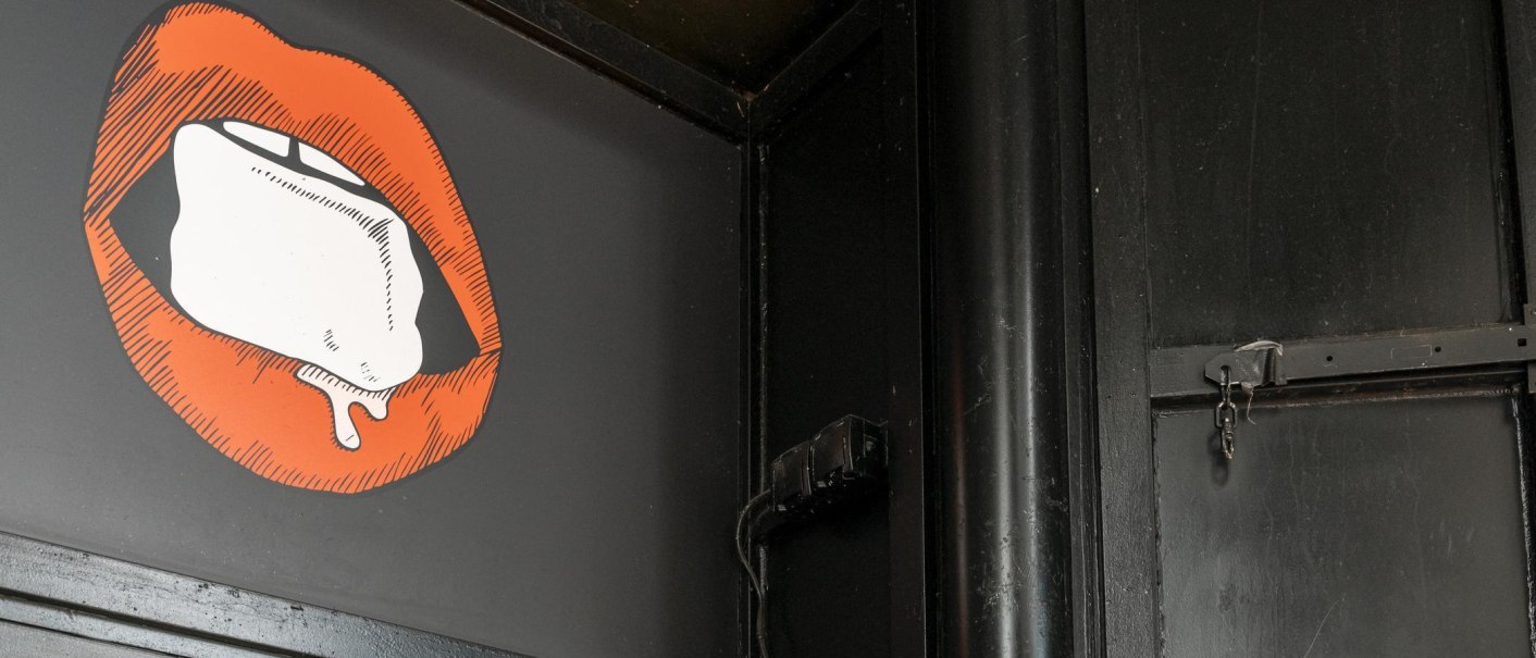 Illustration of red lips with an ice cube on a black background. The surroundings are dark and industrial., © Stuttgart Marketing GmbH, Sarah Schmid