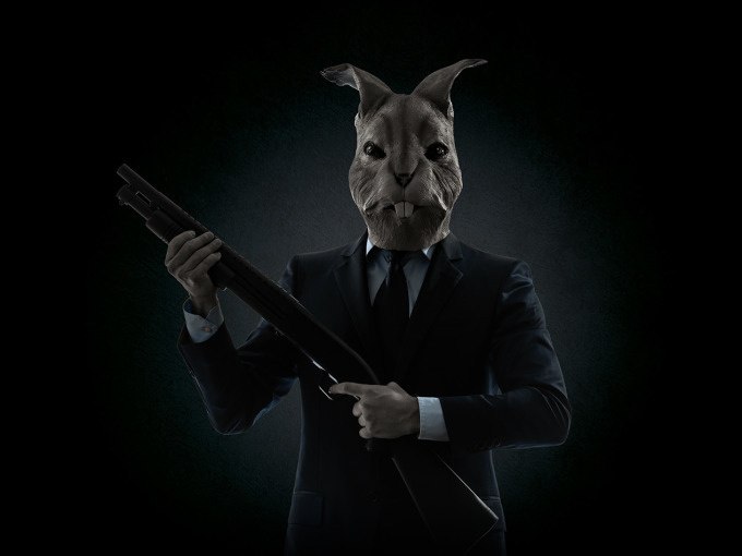 A person in a suit with a rabbit's head holds a rifle in a dark environment., © ExitGames Stuttgart A person in a suit with a rabbit's head holds a rifle in a dark environment., © ExitGames Stuttgart