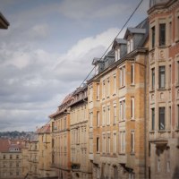 Row of historic buildings with brick facades under a cloudy sky. Other buildings can be seen in the background., &copy; Stuttgart Marketing GmbH, Martina Denker