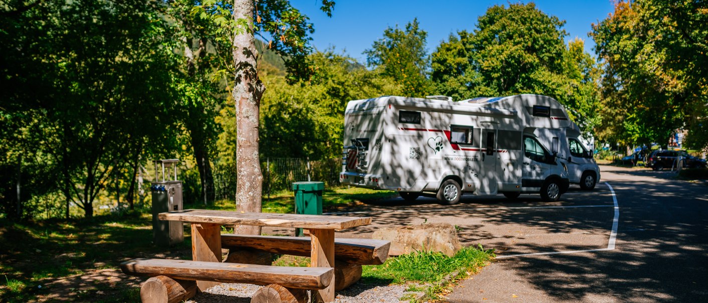 Motorhome site in the countryside with a parked motorhome, picnic table and trees under a blue sky., &copy; Stuttgart-Marketing GmbH, Thomas Niederm&uuml;ller