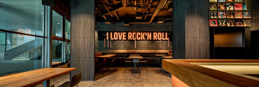 A caf&eacute; with modern furnishings, an illuminated "I Love Rock'n'Roll" sign and record covers on the wall. Wooden tables and chairs can be seen., &copy; Maks Richter