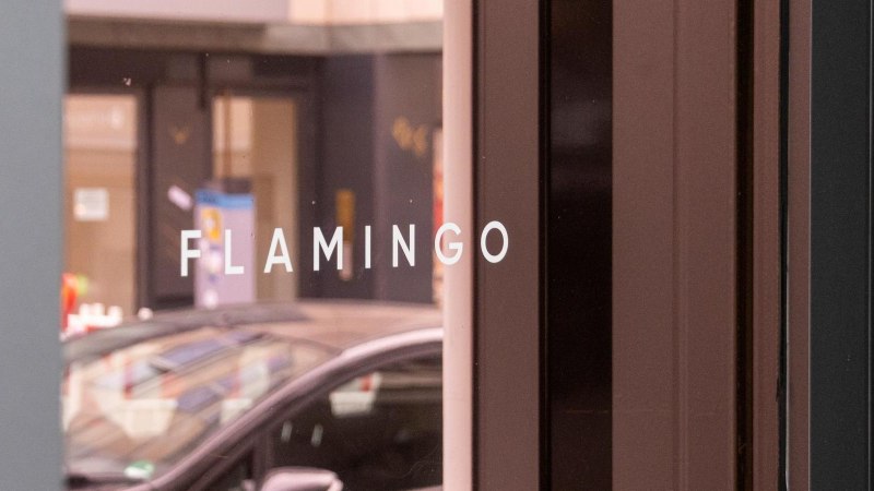 Wei&szlig;er Schriftzug "FLAMINGO" in Gro&szlig;buchstaben auf der verspiegelten Glasfront der Bar, &copy; SMG, Sarah Schmid