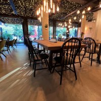 A stylishly furnished restaurant with wooden tables, black chairs and a ceiling full of fairy lights., &copy; heavenskitchen