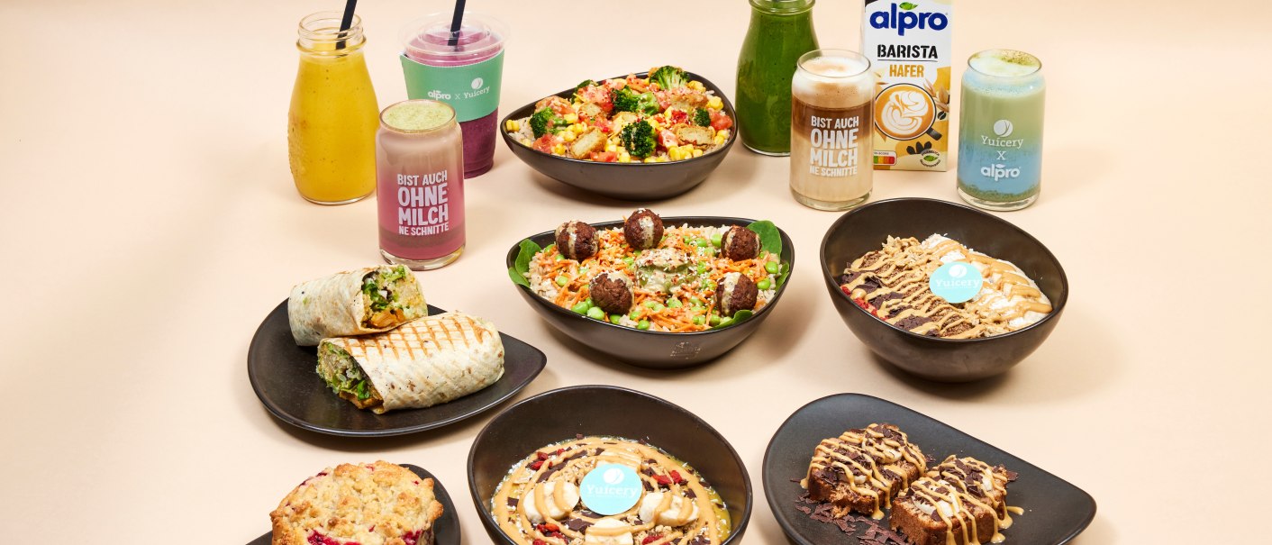 A beige flat lay featuring bowls, wraps, pastries, and smoothies, as well as Alpro and Yucery products., © Yuícery A beige flat lay featuring bowls, wraps, pastries, and smoothies, as well as Alpro and Yucery products., © Yuícery