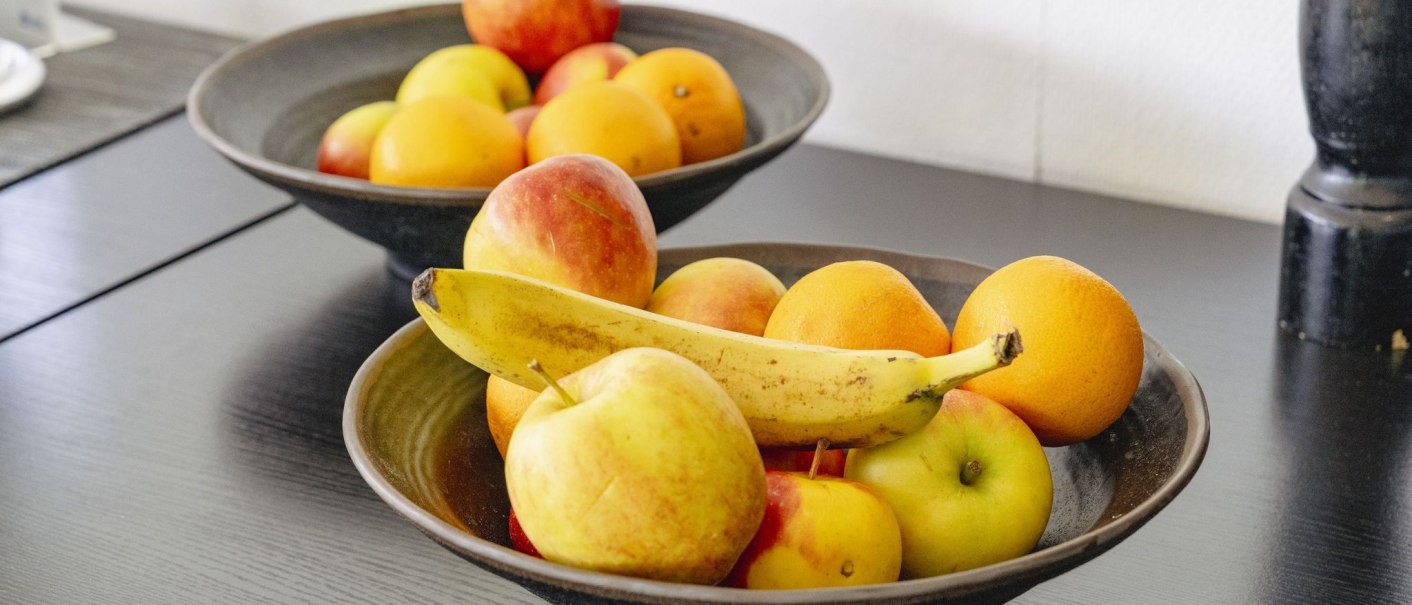 Two bowls of apples, oranges and a banana are placed on a dark table., &copy; Plaza INN Stuttgart-Filderstadt