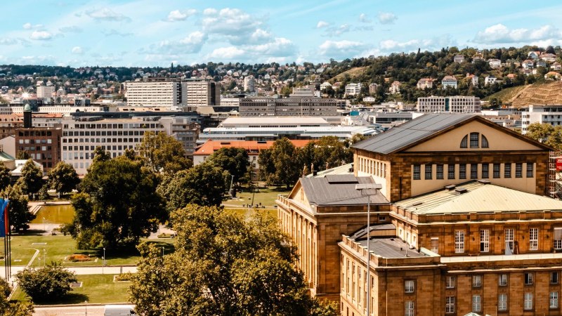 Panoramic view of a city with historic buildings, green parks and hills in the background under a blue sky with clouds., &copy; SMG Stuttgart Marketing GmbH - Sarah Schmid