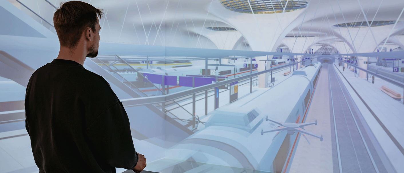 A man stands in front of a virtual projection of a futuristic train station with trains and platforms., &copy; Thomas Niederm&uuml;ller