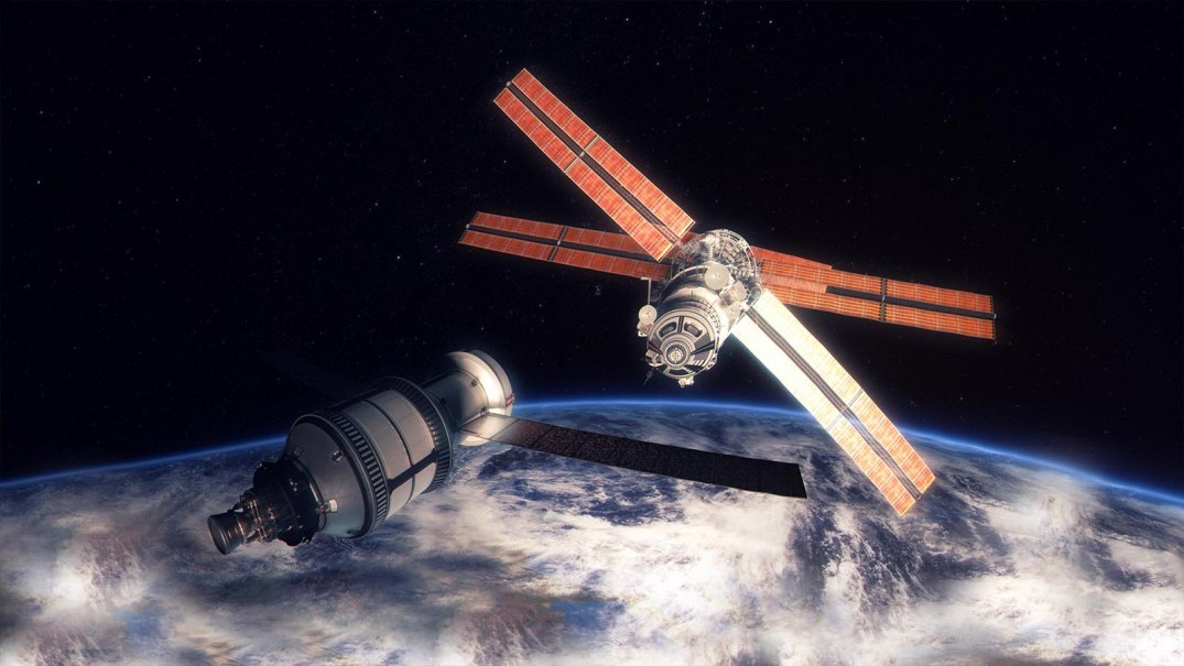 A space capsule approaches a space station in outer space, with the Earth in the background. The station has large solar panels., &copy; Planetarium Stuttgart