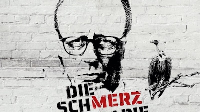 Graffiti eines Mannes mit Brille und Geier auf einer Mauer, Text 'Die Schmerztherapie' in Schwarz und Rot., &copy; Renitenztheater Stuttgart e.V.