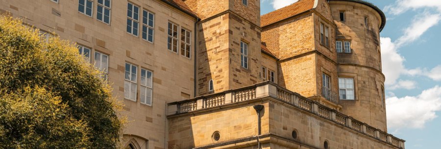 An old castle with striking towers and many windows, surrounded by a blue sky and a few clouds., © Stuttgart-Marketing GmbH, Sarah Schmid