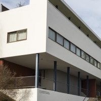 Modern building with a white façade and large windows, surrounded by trees and a billboard., © SMG Stuttgart Marketing GmbH - Sarah Schmid Modern building with a white façade and large windows, surrounded by trees and a billboard., © SMG Stuttgart Marketing GmbH - Sarah Schmid