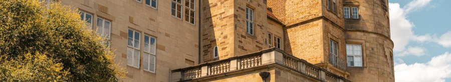 An old castle with striking towers and many windows, surrounded by a blue sky and a few clouds., © Stuttgart-Marketing GmbH, Sarah Schmid