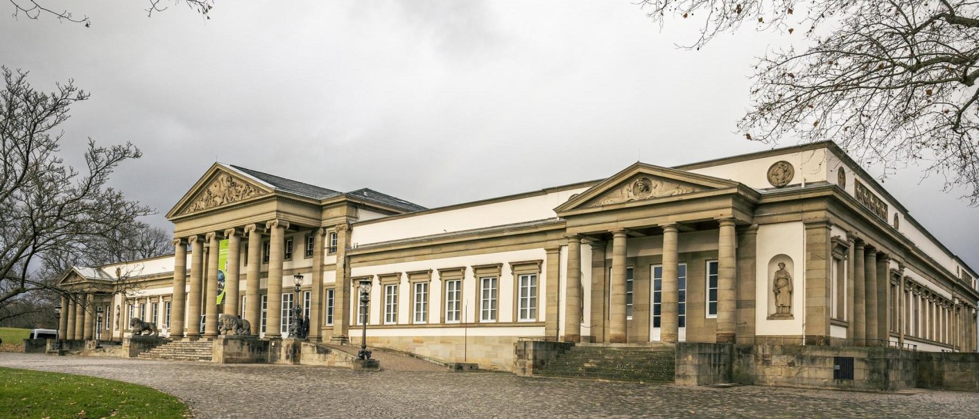 Rosenstein Castle with its classical fa&ccedil;ade and columns, surrounded by bare trees and a cloudy sky., &copy; Stuttgart Marketing GmbH, Sarah Schmid