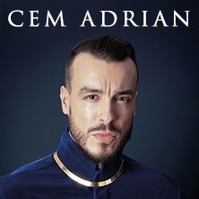 Portrait of a man in a blue suit with a gold necklace against a dark background. The name 'Cem Adrian' is written at the top., &copy; see on the left