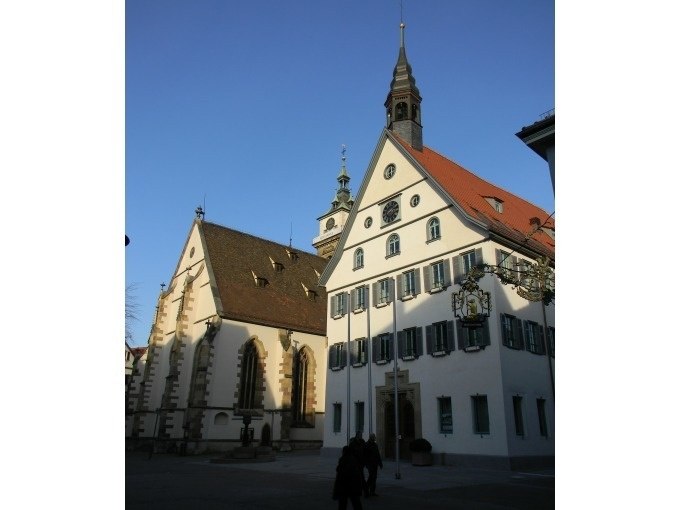 Historic buildings in Bad Cannstatt, including a church and a half-timbered house, under a clear sky and sunshine., &copy; Cool-Tours StattReisen