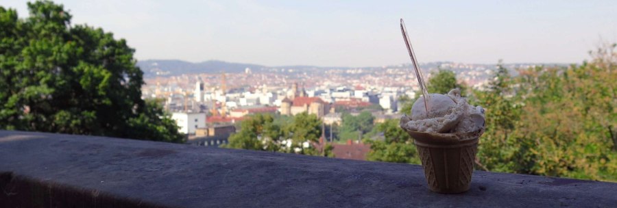 An ice cream sundae stands on a wall, with a cityscape with trees and buildings in the background., &copy; Stuttgart-Marketing GmbH