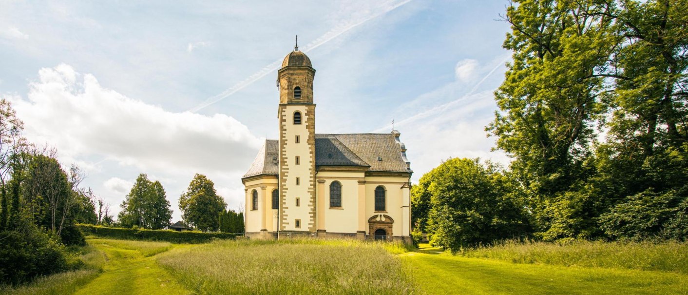 The Baroque church of St. Mary on the Hohenrechberg stands picturesquely amid a green meadow and trees under a blue sky., &copy; SMG Stuttgart Marketing GmbH - Sarah Schmid