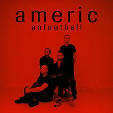 Four people pose in a red-lit room under the lettering 'American Football'., &copy; see on the left