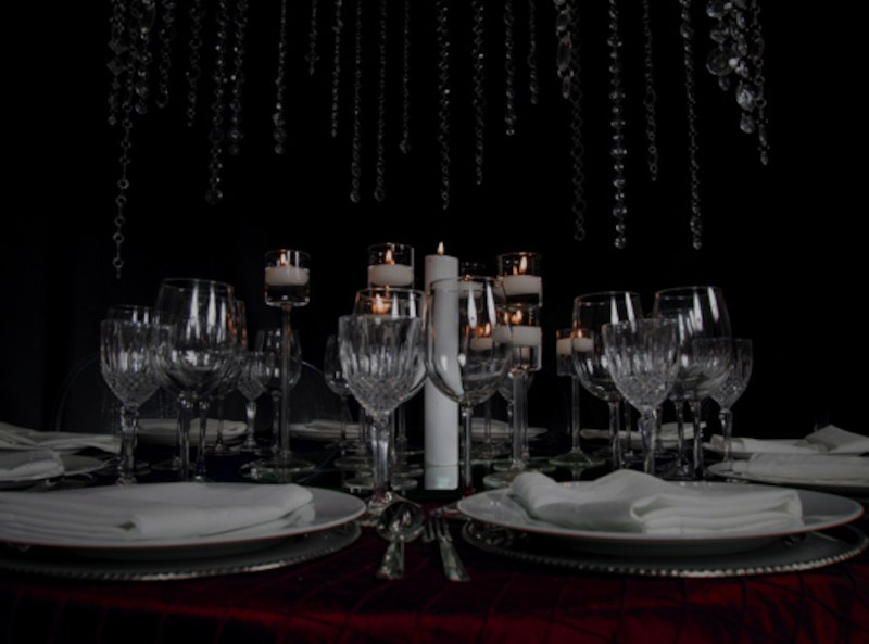 Elegant table with crystal glasses, white plates and burning candles in a dark setting., &copy; engesser marketing GmbH