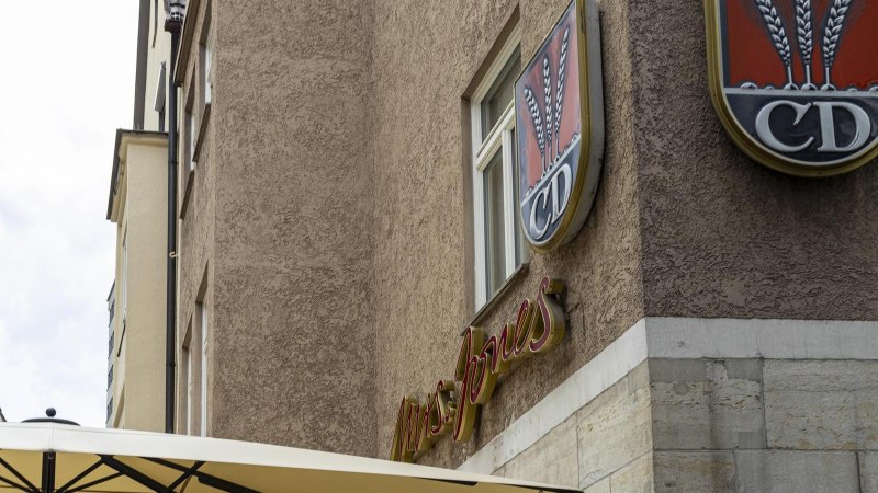 A building with the lettering 'Mrs Jones' and a logo with ears of corn and the letters 'CD'. A parasol is visible in the foreground., &copy; SMG, Sarah Schmid