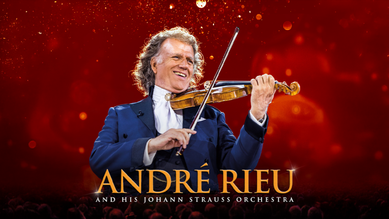 André Rieu spielt Geige mit einem Lächeln vor einem funkelnden roten Hintergrund. Der Text darunter kündigt seine Tour mit dem Johann Strauss Orchester an., © links im Bild André Rieu spielt Geige mit einem Lächeln vor einem funkelnden roten Hintergrund. Der Text darunter kündigt seine Tour mit dem Johann Strauss Orchester an., © links im Bild