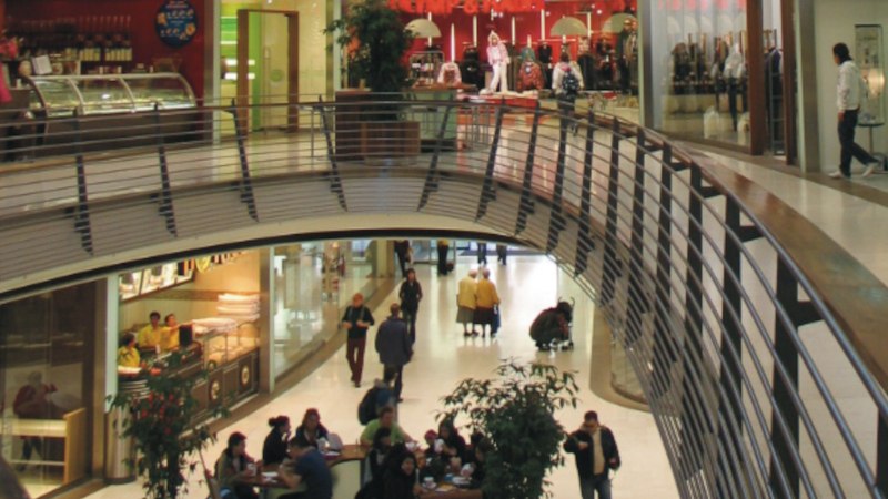 Innenansicht der K&ouml;nigsbau Passagen mit Gesch&auml;ften und Menschen auf zwei Etagen. Eine geschwungene Br&uuml;cke verbindet die Bereiche., &copy; Stuttgart-Marketing GmbH