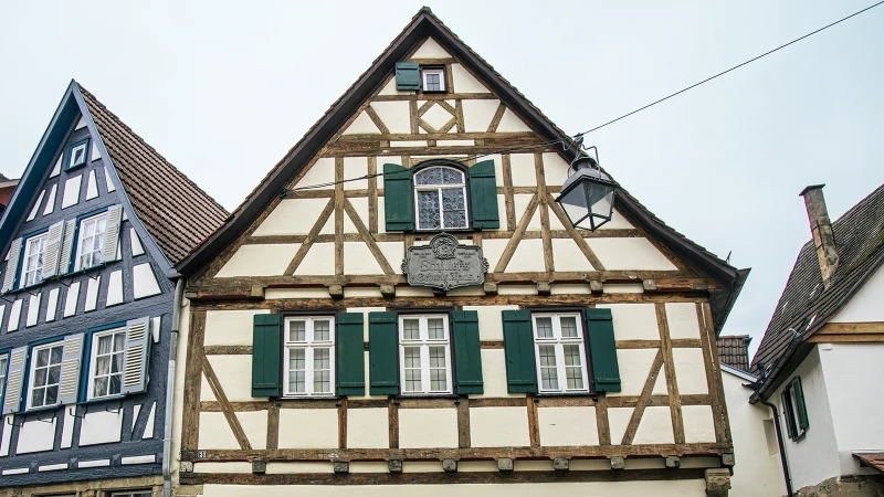 Fachwerkh&auml;user in Marbach am Neckar, darunter Schillers Geburtshaus mit gr&uuml;nem Fensterladen und historischem Schild., &copy; SMG, Sarah Schmid
