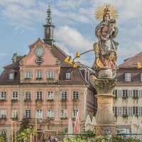 A Baroque statue in a town square, surrounded by historic buildings with half-timbered and ornate facades. The sky is slightly cloudy., &copy; Mario Klaiber