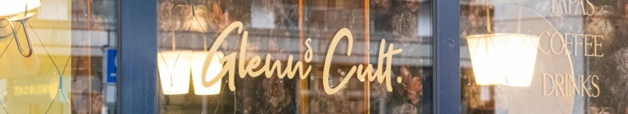 Window of a caf&eacute; with the lettering 'Glenn's Cult' and offers such as Aperitivo, Lunch, Tapas, Coffee, Drinks, Vino, Spirits., &copy; SMG, Sarah Schmid