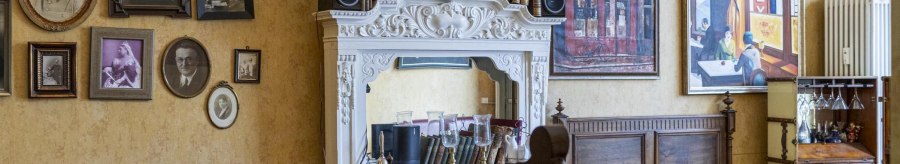 A cozy café with antique furniture, framed pictures and decorative elements on the walls., © SMG, Sarah Schmid