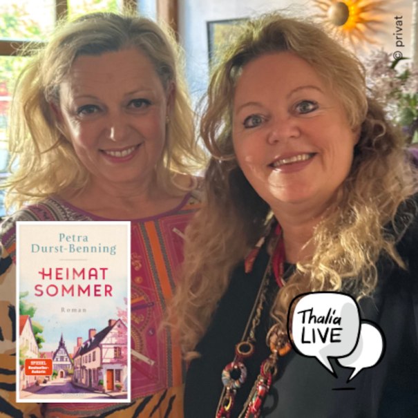 A woman sits on a sofa with the cover of Petra Durst-Benning's book 'Heimatsommer' next to her. A rustic piece of furniture in the background., &copy; Thalia Deutschland GmbH & Co. KG