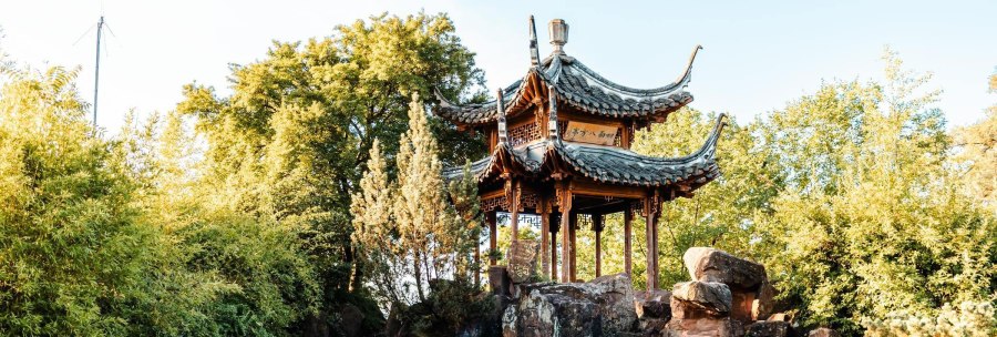 A traditional Chinese pavilion stands on a rock surrounded by lush greenery in Stuttgart's Chinese Garden., © SMG Stuttgart Marketing GmbH - Sarah Schmid