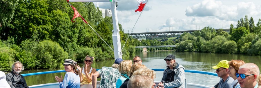 People enjoying a boat trip on the Neckar. They are sitting on the deck, surrounded by green countryside and chatting happily., © all copyrights are reserved by maks richter People enjoying a boat trip on the Neckar. They are sitting on the deck, surrounded by green countryside and chatting happily., © all copyrights are reserved by maks richter