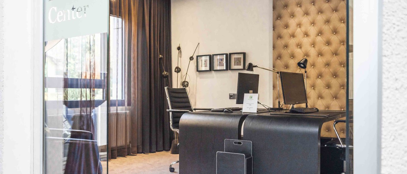 An elegant office with desks, chairs and computers, visible through a glass door labeled 'Business Center'., &copy; Chandler Photography