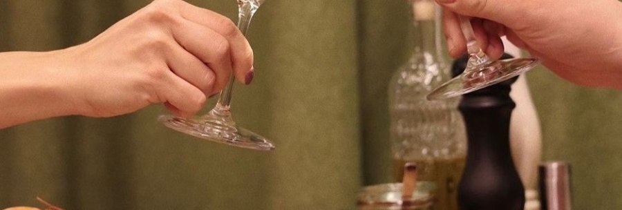 Two people toast with glasses of white and red wine, surrounded by pasta, bread and vegetable dishes on a table., &copy; Roberts