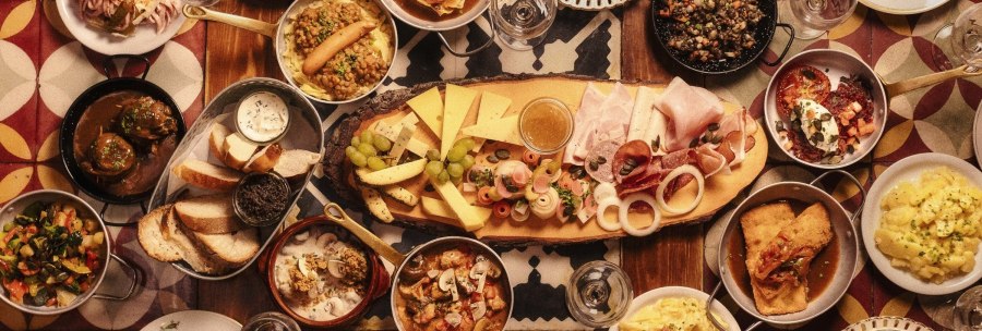 A table full of traditional German dishes, including cheese, sausage, bread, lentils, potatoes and various side dishes., &copy; &copy; Gasthaus B&auml;ren Stuttgart