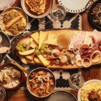 A table full of traditional German dishes, including cheese, sausage, bread, lentils, potatoes and various side dishes., &copy; &copy; Gasthaus B&auml;ren Stuttgart