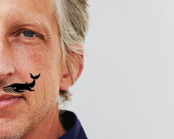 Close-up of a man with gray hair, a blue shirt and a small whale tattoo on his cheek., &copy; Renitenztheater Stuttgart e.V.