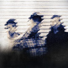 Drei Personen stehen vor einem gestreiften Hintergrund. Das Bild ist verschwommen, was den Eindruck von Bewegung vermittelt., &copy; links im Bild