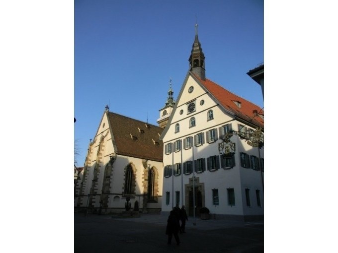 Historic buildings in Bad Cannstatt, including a church and a half-timbered house, under a clear sky and sunshine., &copy; Cool-Tours StattReisen