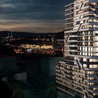 A modern high-rise building with a unique design at night, illuminated, with a cityscape in the background., &copy; Jaz Hotel Stuttgart