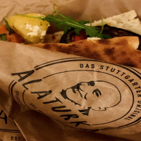 A sandwich with vegetables and cheese in an Alaturka paper bag labeled "The Stuttgart Original"., © Stuttgart-Marketing GmbH A sandwich with vegetables and cheese in an Alaturka paper bag labeled "The Stuttgart Original"., © Stuttgart-Marketing GmbH