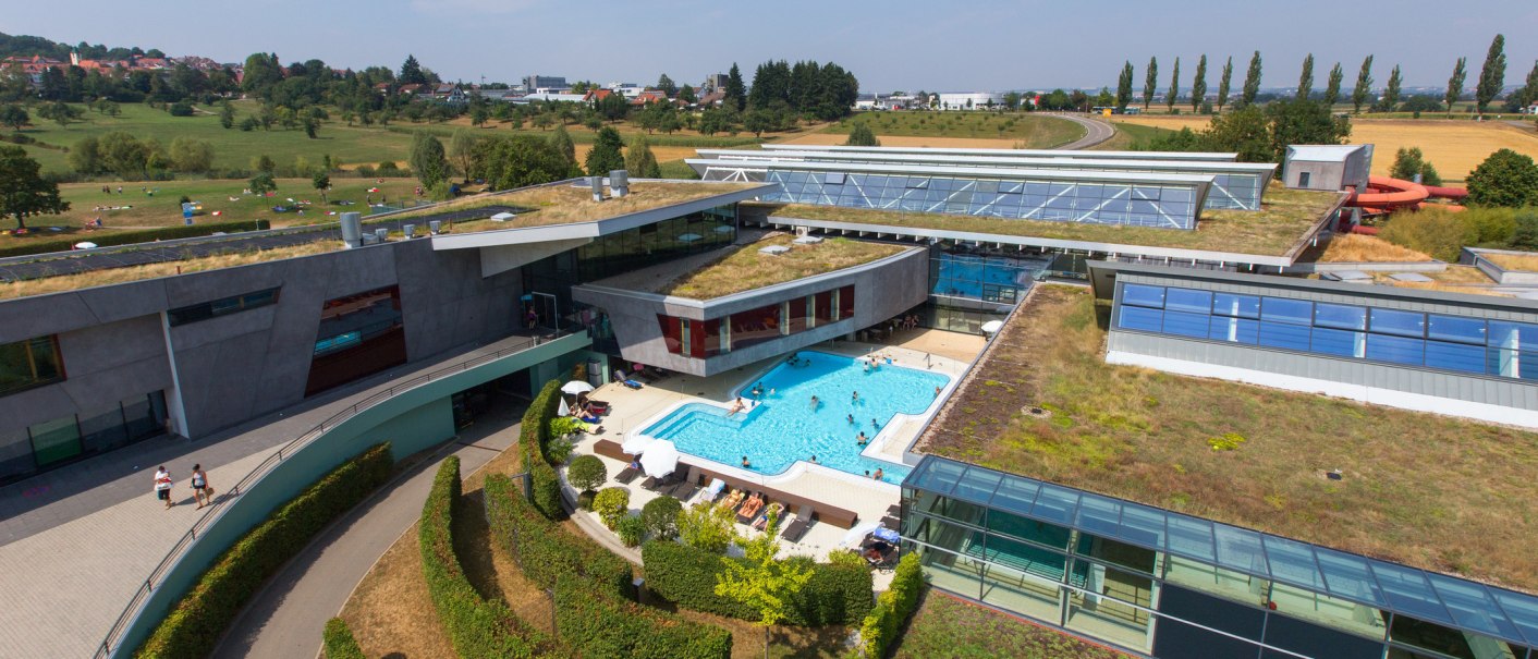 Aerial view of the Fildorado in Filderstadt. The building has a green roof and an outdoor pool. Meadows and trees can be seen in the background., © © Stuttgart-Marketing GmbH Aerial view of the Fildorado in Filderstadt. The building has a green roof and an outdoor pool. Meadows and trees can be seen in the background., © © Stuttgart-Marketing GmbH