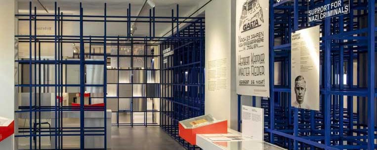An exhibition room with blue lattice structures, historical posters and information material on the walls., © Haus der Geschichte Baden-Württemberg