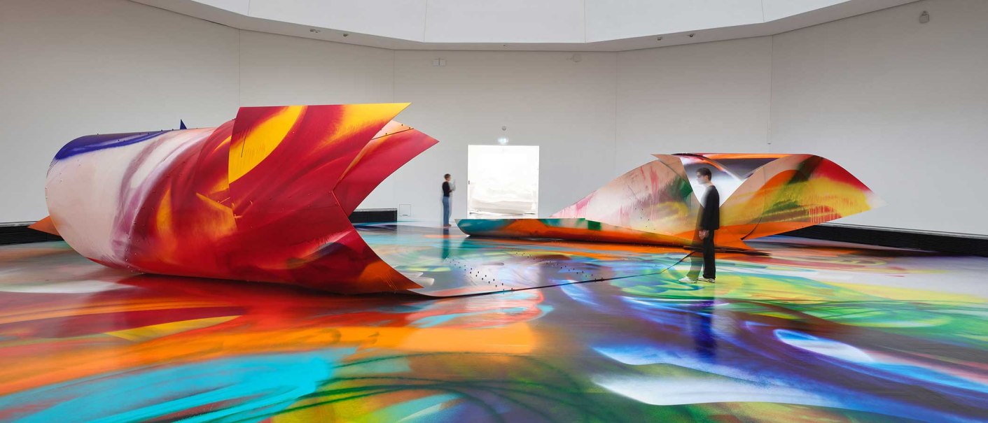 Bunte, großflächige Installation von Katharina Grosse in einer Galerie. Zwei Personen betrachten die farbenfrohen Strukturen und den bemalten Boden., © VG Bild-Kunst, Bonn 2025 Bunte, großflächige Installation von Katharina Grosse in einer Galerie. Zwei Personen betrachten die farbenfrohen Strukturen und den bemalten Boden., © VG Bild-Kunst, Bonn 2025