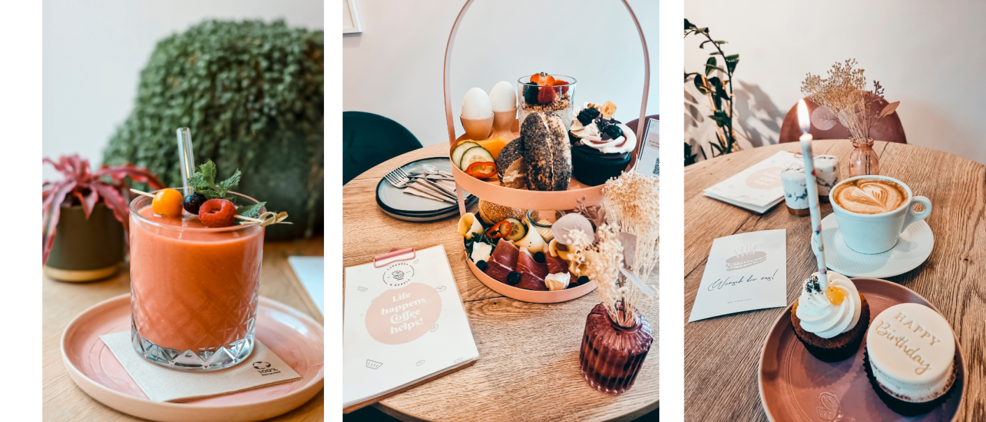 Ein Smoothie mit Beeren, ein Frühstückstablett mit Bagels und Cupcakes, und ein Cappuccino mit einem Geburtstags-Cupcake auf einem Tisch., © Cupcakes & Bagels, Stuttgart Ein Smoothie mit Beeren, ein Frühstückstablett mit Bagels und Cupcakes, und ein Cappuccino mit einem Geburtstags-Cupcake auf einem Tisch., © Cupcakes & Bagels, Stuttgart